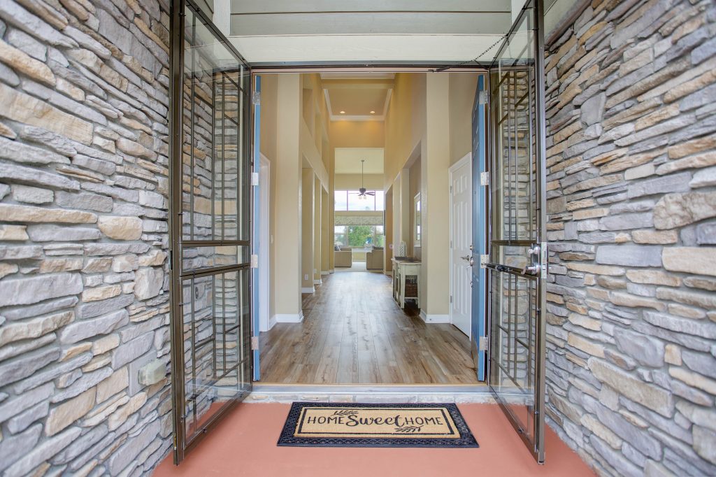 Open front doors leading into a light-filled entry at a home previously represented by McFall Draheim Group